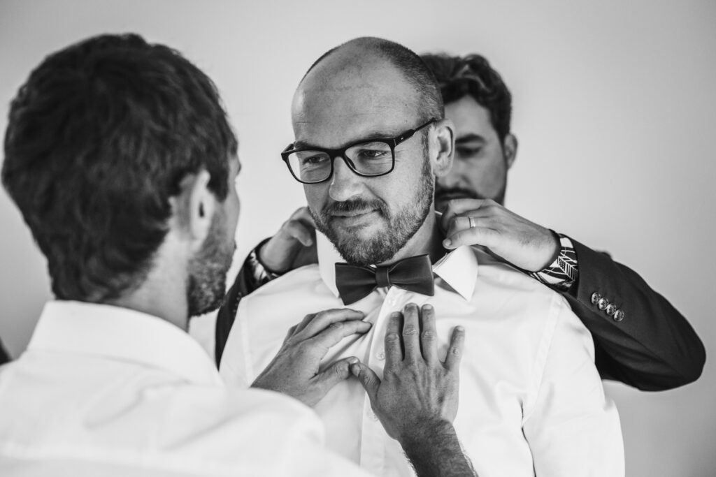 le futur marié se prépare avec l'aide de ses témoins, photo réalisée par un photographe professionnel